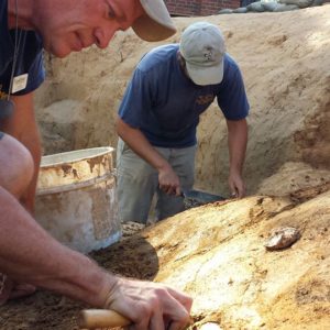 Archaeologists excavating artifacts