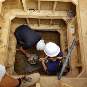 Archaeologist and scientist augur in a well