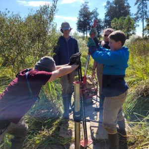 Staff archaeologists Caitlin Delmas, Hanna Barch, Gabriel Brown, and Intern Eli Clem vibracoring in the Pitch and Tar Swamp.