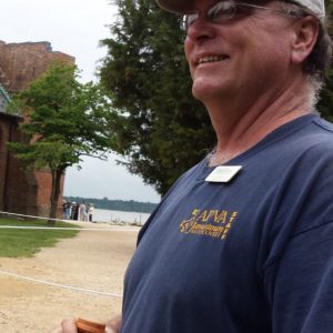 Archaeologist smiling at object off camera