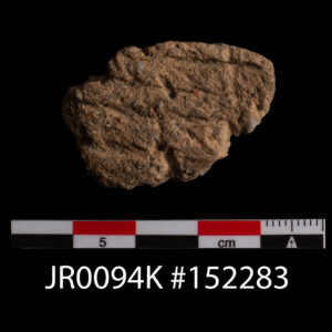 A sherd of Native ceramic. It is tempered with pebbles and sand and is cord-marked in an "S"-twist orientation on its exterior. This sherd was excavated from a 17th-century ditch that cut earlier fort-period features.