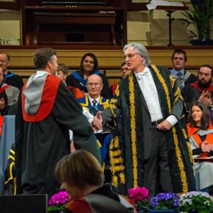 Man graduating and shaking hands with professor