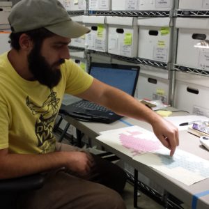 Staff pointing to map of archaeological units