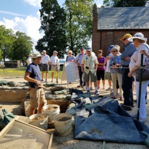 Archaeologist talking to large group