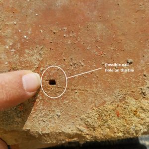 Close-up of square hole in ceramic tile