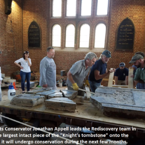 Staff moving tombstone fragments onto cart