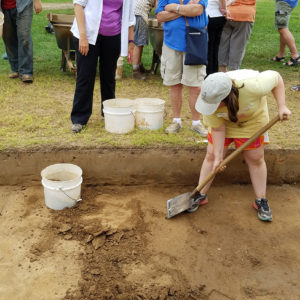 Group watches excavator shoveling