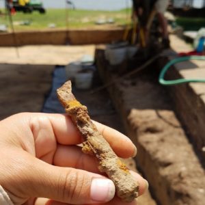 Hand holding bone knife handle