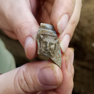 Stoneware jug sherd with molded lion's head decoration