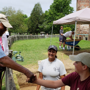 MAn shakes hands with archaeologist