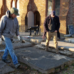 two men standing in a churchyard