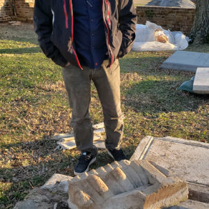 Archaeologist examines monument fragment