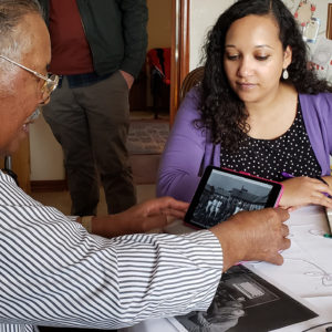 Man and woman examine historical photographs