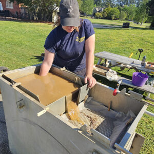 Curator Leah Stricker uses the flotation machine to process one of the soil samples.