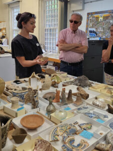 Assistant Curator Emma Derry shares artifacts with visitors in an "Inside the Vault" tour.