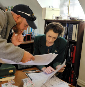 Senior Staff Archaeologist Sean Romo and Public Historian Dr. Amy Stallings analyzing 17th-century maps of Jamestown Island.