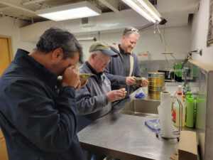 Drs. Dominick Ciruzzi, C. Rick Berquist, and James Kaste examine some of the stones excavated from the Governor's Well.