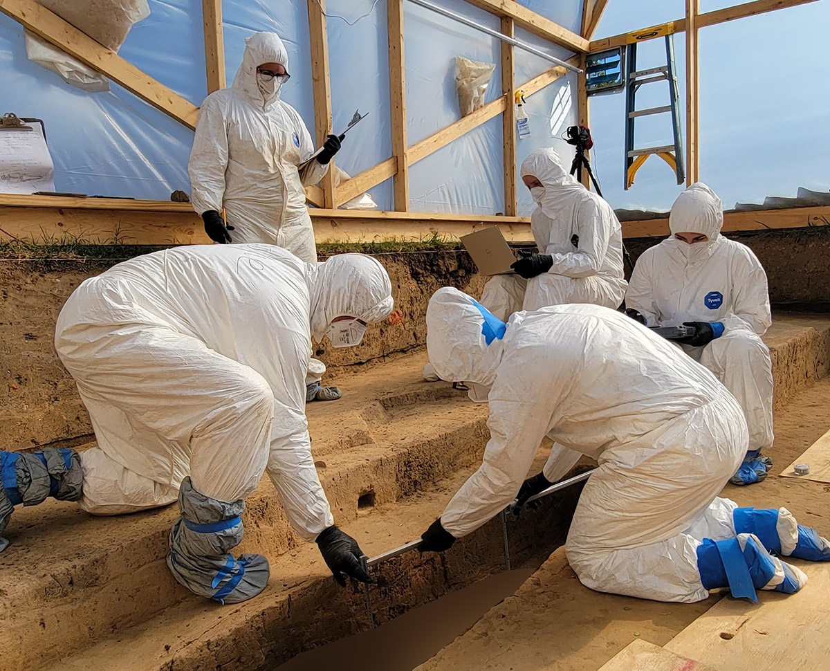 The team taking measurements of one of the individuals (human remains intentionally obscured).