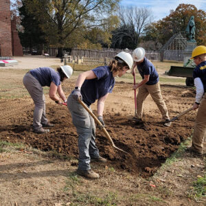 Backfilling the burial excavations. The Gator is used to help pack the soil down.