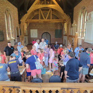 Campers from the first session share the artifacts they found with their families.