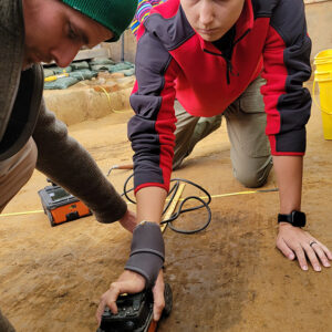 Staff Archaeologist Gabriel Brown and Site Supervisor Anna Shackelford use ground-penetrating radar (GPR) to survey one of the graves at the 1607 burial ground.