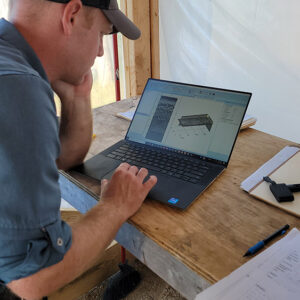 Director of Archaeology Sean Romo examines the results of a ground-penetrating radar scan of one of the graves at the 1607 burial ground.