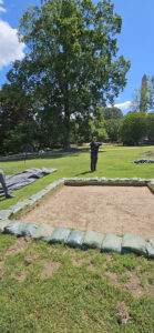 Director of Archaeology Sean Romo approximates one of the corners of the brick cellar feature as revealed by ground-penetrating radar.