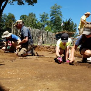 Students troweling in an excavation unit