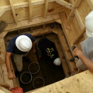 Archaeologists excavating a well