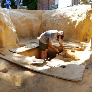 Student excavating a well shaft