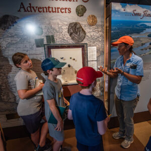 Senior Staff Archaeologist Mary Anna Hartley discusses the significance of some of the artifacts of the Gentleman Soldiers exhibit in the Archaearium museum.