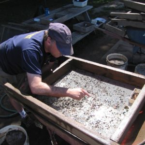 Archaeologist screens for artifacts