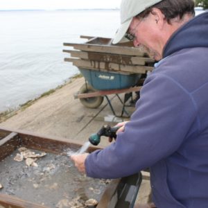 Archaeologist screening artifacts