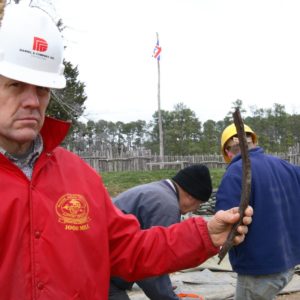 Archaeologist shows artifact to camera