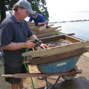 Archaeologists screen artifacts