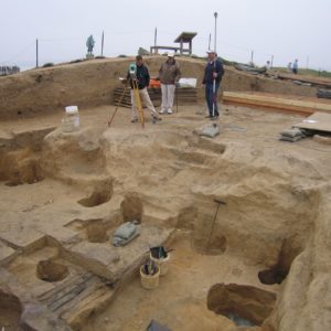 Archaeologists record cellar features with a transit station