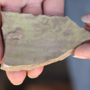 Hands holding an earthenware sherd