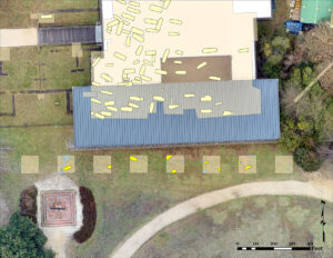 A map of the current excavations just south of the Archaearium. The eight squares are the location of the current dig. Bright yellow features are newly-found burials. The dull yellow features to the north are burials found in the early 2000s. The remains of the possible early building are depicted in light blue in the second square.