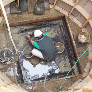 Archaeologist excavating in a well