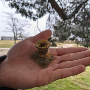 hand holding a case bottle lip and neck fragment