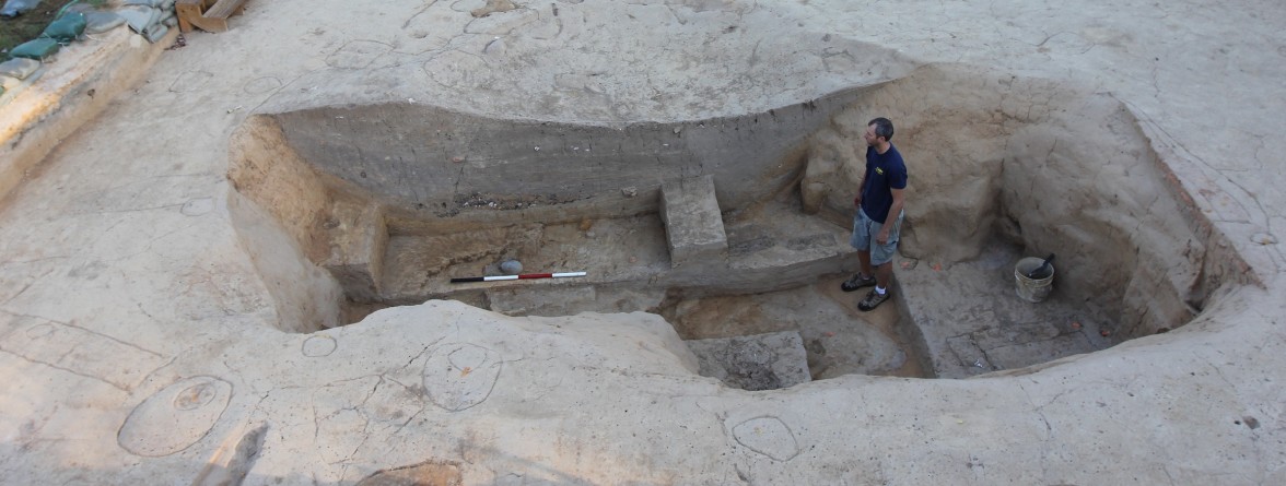 Archaeologist standing in an excavated cellar