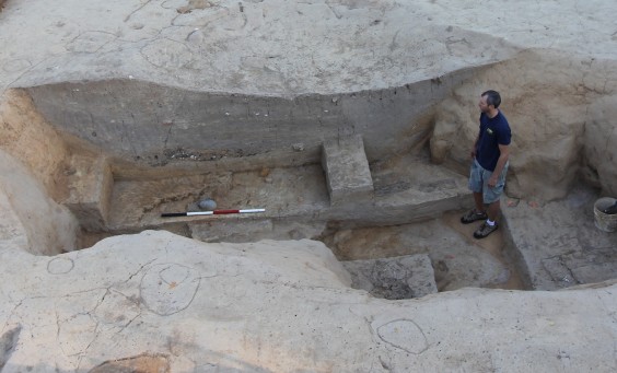 Archaeologist standing in an excavated cellar