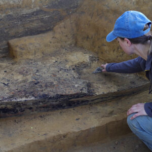 Staff Archaeologist Natalie Reid excavates the charcoal layer from the 1608 ditch near the well.