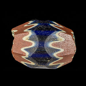 Side view of a red, white, and blue bead