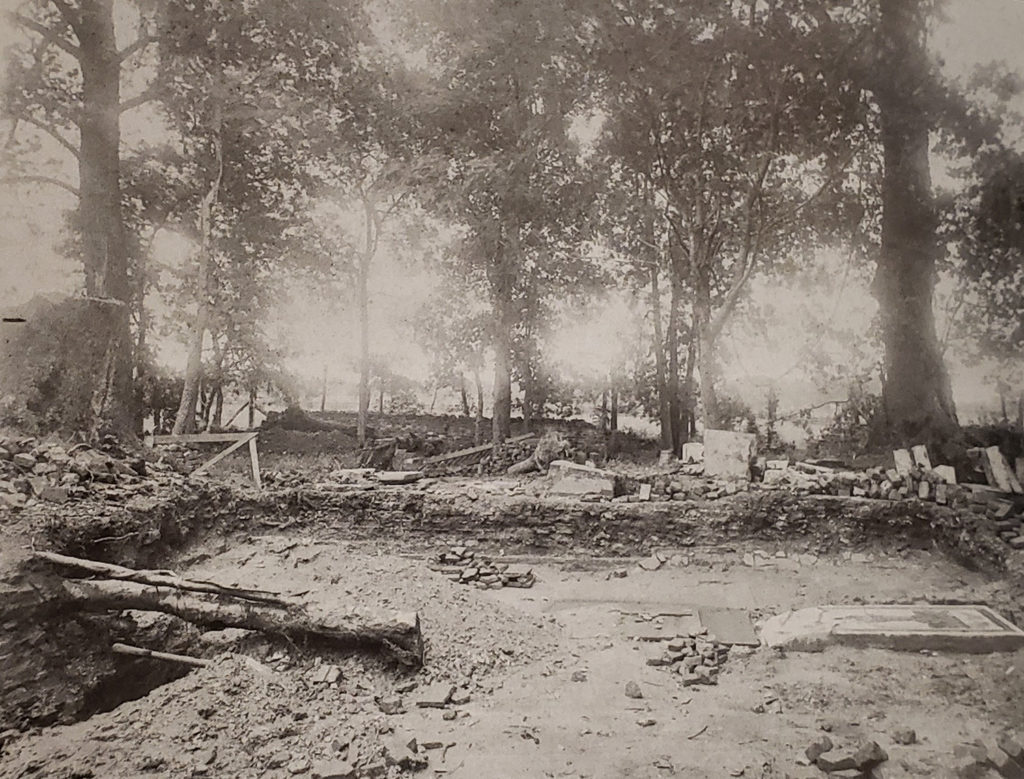 Black-and-white photograph of churchyard excavations