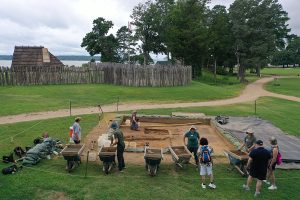 Field school students interact with the public as they screen soil from the cellar excavations.