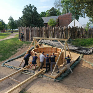 The team gives the final push for placement of the protective well ring into the observation platform.