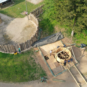 The archaeological team positions the protective well ring for lowering into the observation platform.