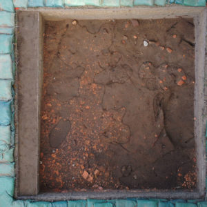 This excavation unit north of the Church Tower shows what may be the remnants of the 1640s brick church construction deposit. Features in the unit have been scored with a trowel to make them easier to distinguish.