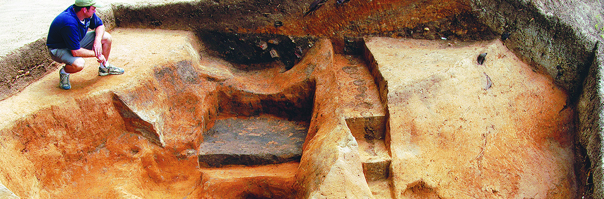 Archaeologist examines excavations